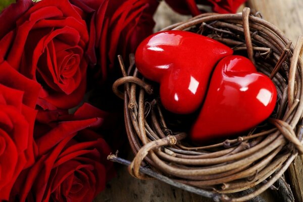 Red roses near the basket with hearts