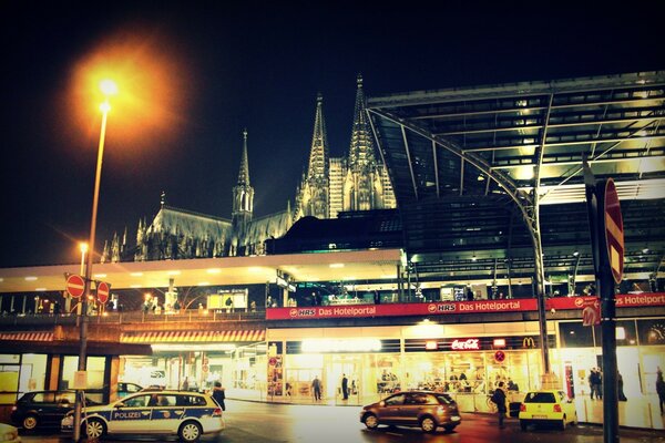 Abendstraße mit Geschäften und Autos