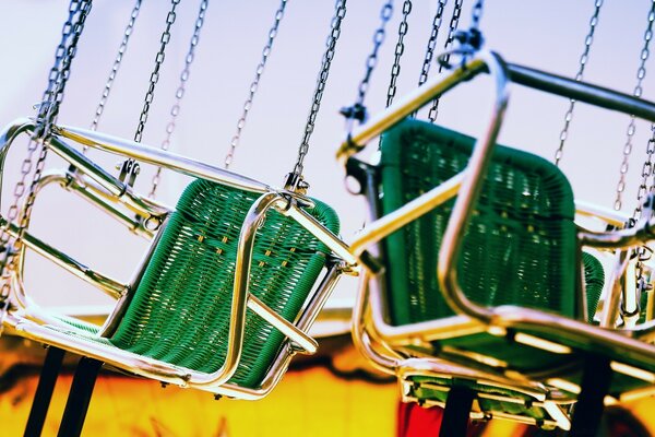 Chain carousel. Two green seats