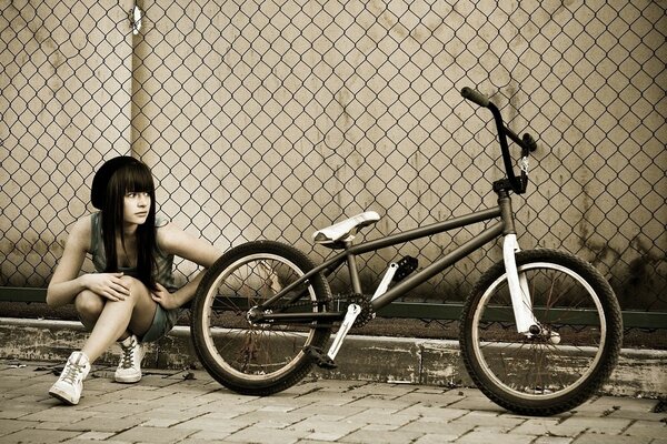 A beautiful athlete girl with a bicycle