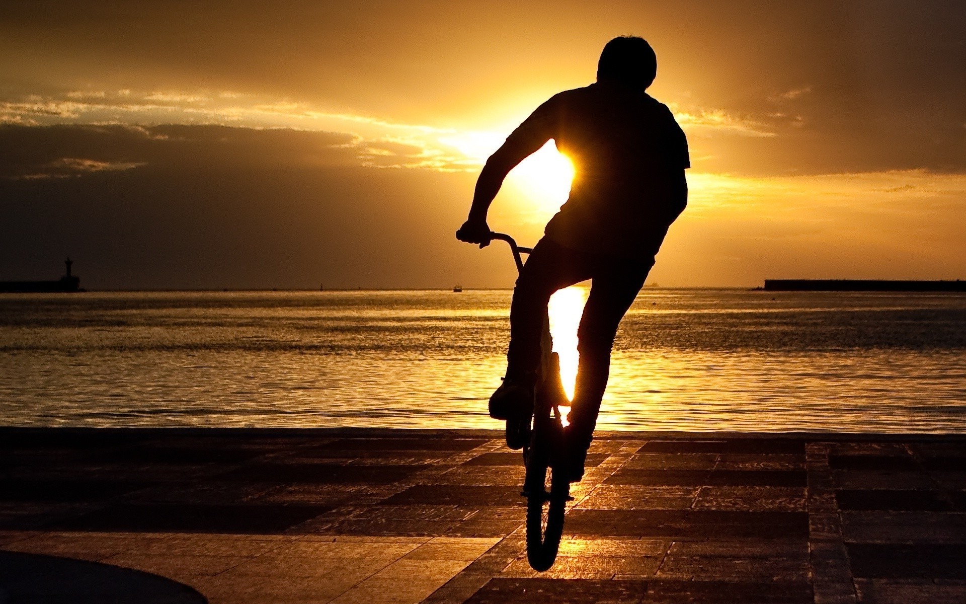 cycling sunset beach sea water sun ocean dawn silhouette sky