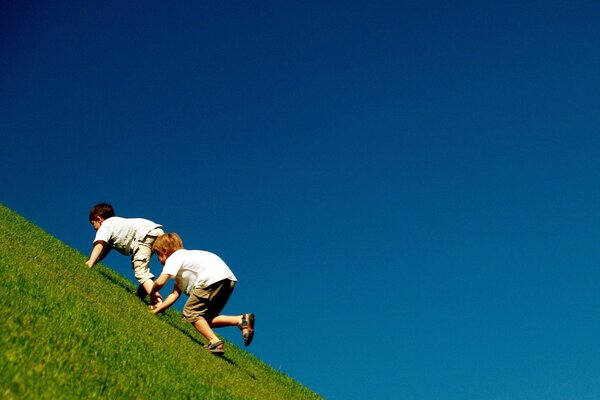 Children climb on the mountain surface