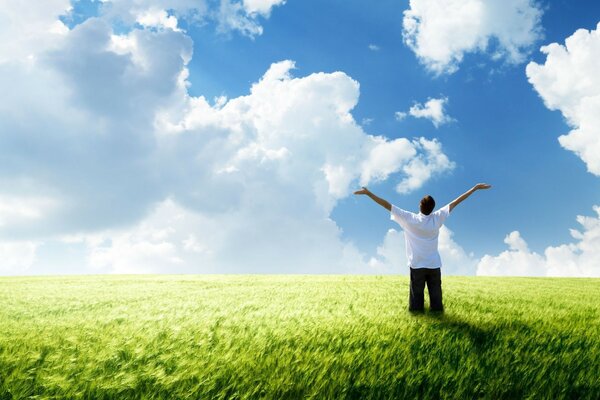 A happy man stands in a field