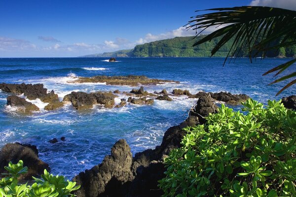 Boulders block the entrance to the bay of the tropical island