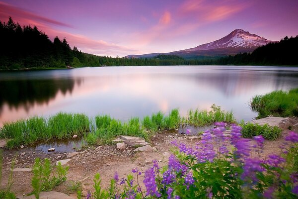 An unusually beautiful sunset on the background of a lake and mountains