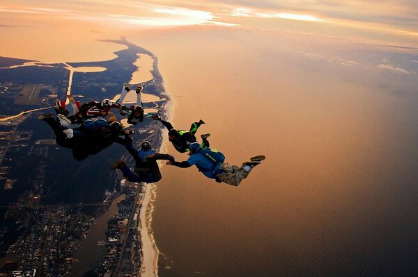 A group of parachutists locked in a ring in a jump