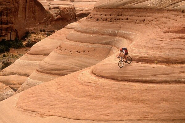 Cyclist conquers a mountain of sand