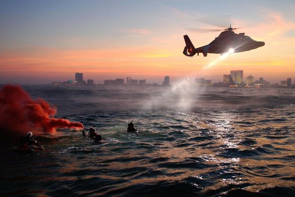 The helicopter performs a rescue operation on the water