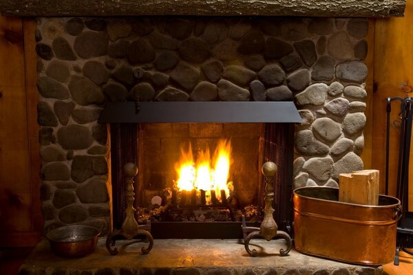 The warm flame of the fireplace in a cozy wooden house