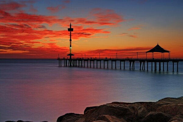 The long pier goes far into the calm sea