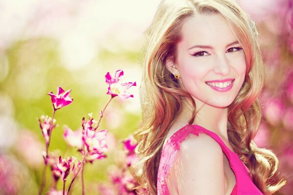 Actress in a pink dress in nature