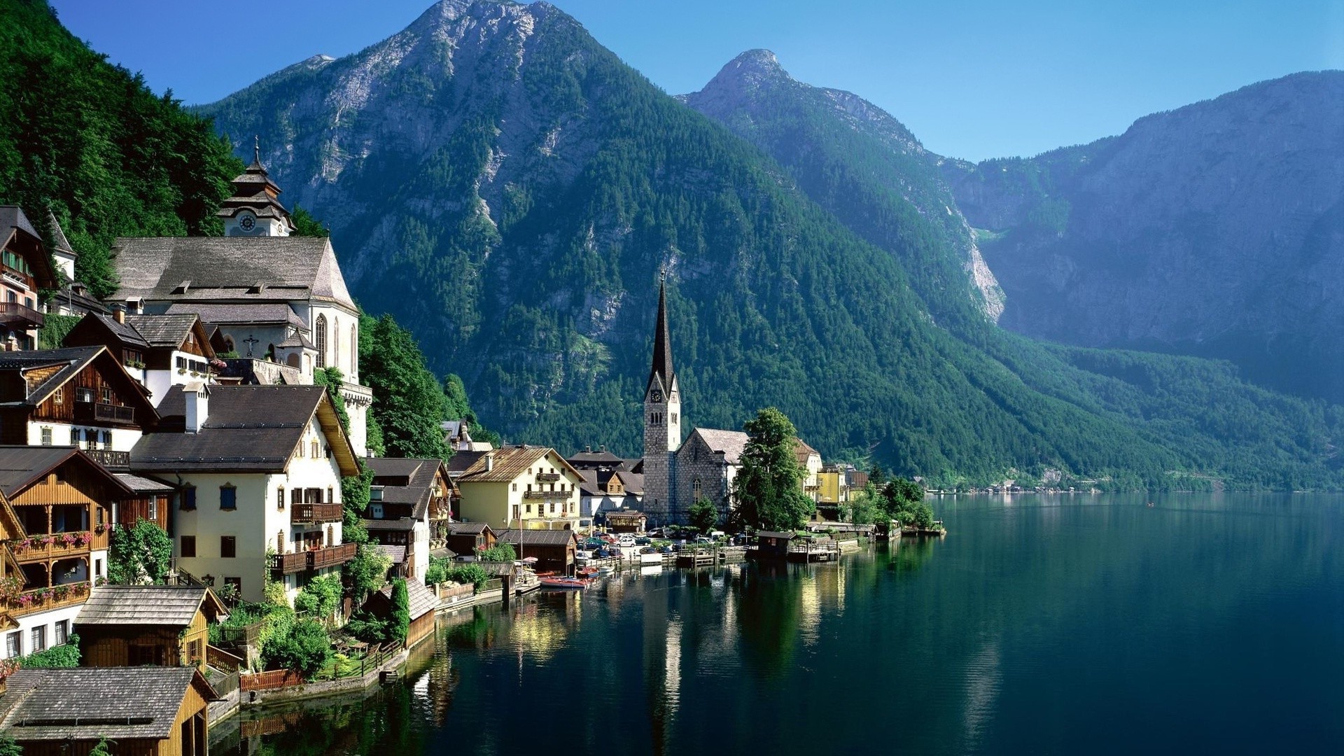 cidade água viagens lago montanhas arquitetura ao ar livre casa paisagem colina natureza céu reflexão cênica luz do dia cidade turismo fiorde