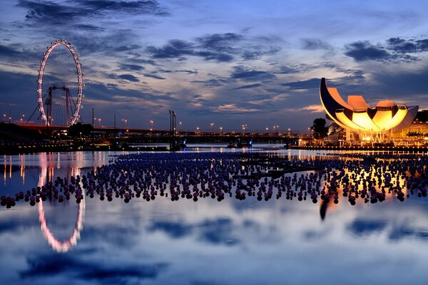 The architecture of the city at sunset. Reflection of the sky in the water during the journey