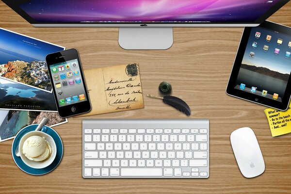 Traveler s desktop, keyboard, monitor, tablet, gadgets, antique postcard, inkwell with pen, bowl of ice cream