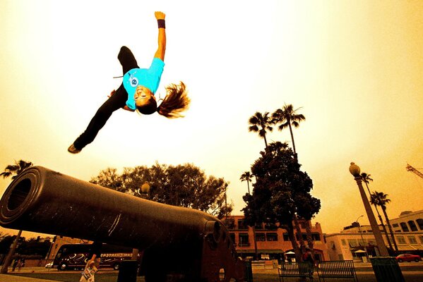 Parkour. The girl performs a side flip from an obstacle