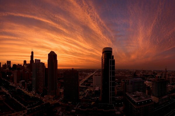 Skyscrapers under a red sky at sunset