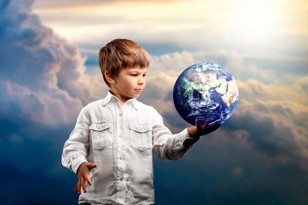 The boy holds the globe in his right hand