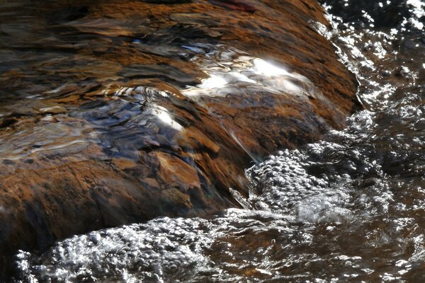 Stream water flows down from the stones