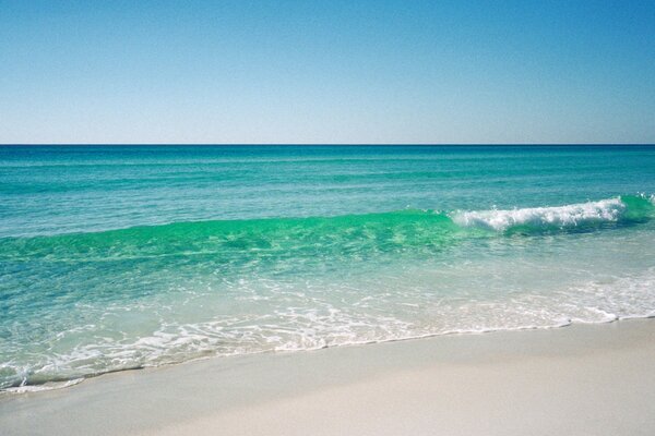 SURF ON A WHITE BEACH AT NOON