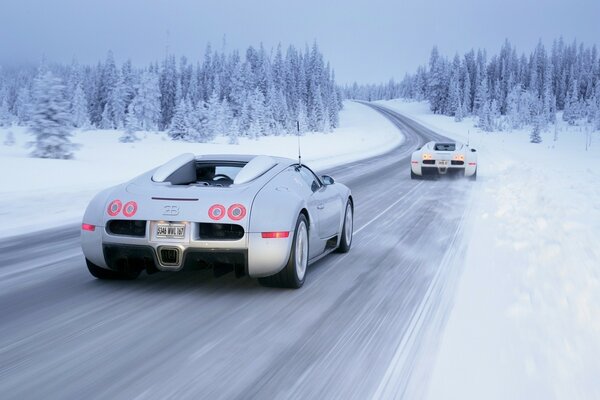 Cars drive by on the road in winter