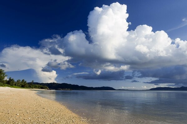 The sandy shore of the azure sea