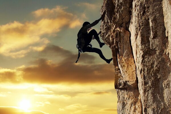 Climber climbs sunset mountain