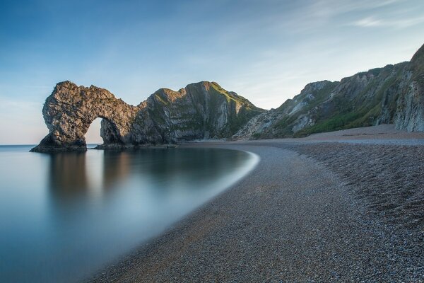 An arch in a rock located on a coastal spit