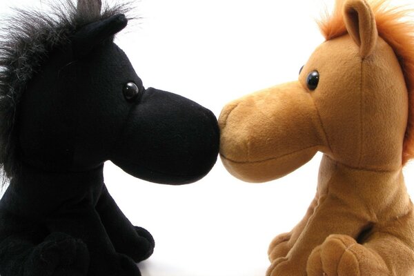 Toy horses seem to be kissing