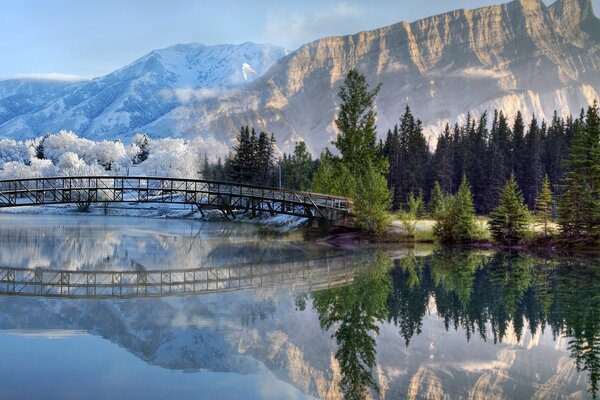 Metal bridge in the shape of an arch on the background of mountain peaks