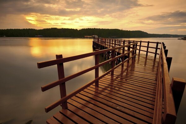 Wooden pier by a wide river