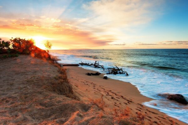 Belle vue sur le coucher de soleil sur la plage au bord de la mer