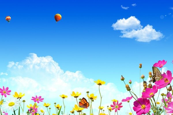 Blumenwiese mit hellen Blumen und blauem Himmel mit Luftballons