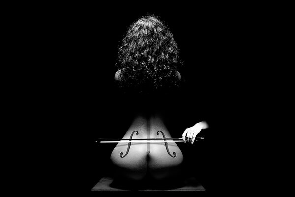 Black and white photo of a nude woman stylized as a cello