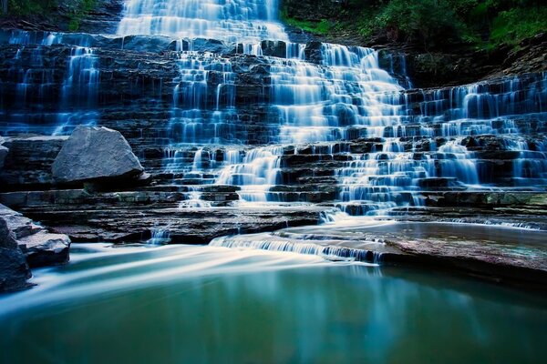 A huge pool of a magnificent waterfall