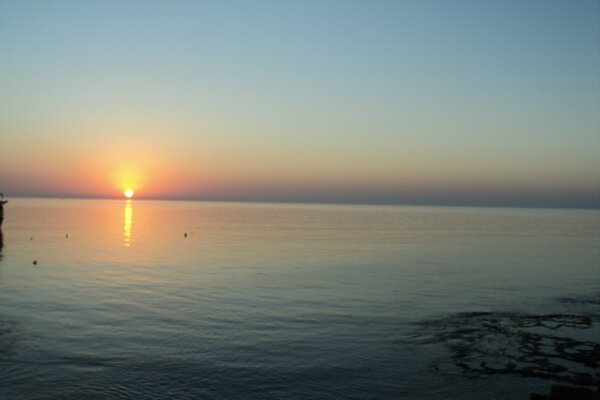 Sunset over the calm ocean water