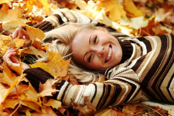 Autumn mood. In a pile of maple leaves