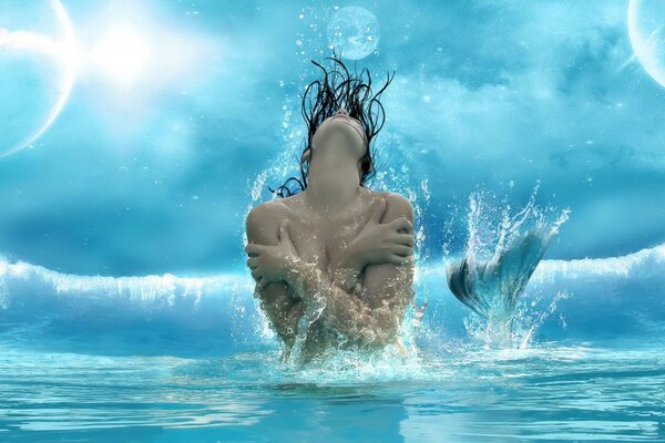 A woman in the form of a mermaid poses in the water