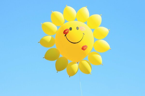 A sun made of balloons on a blue sky background