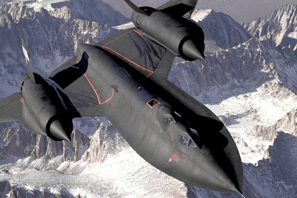 Black fighter in flight in snowy mountains