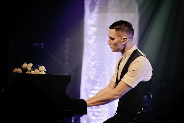 A man plays the piano at a concert