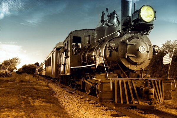 A train on a railroad with a US flag