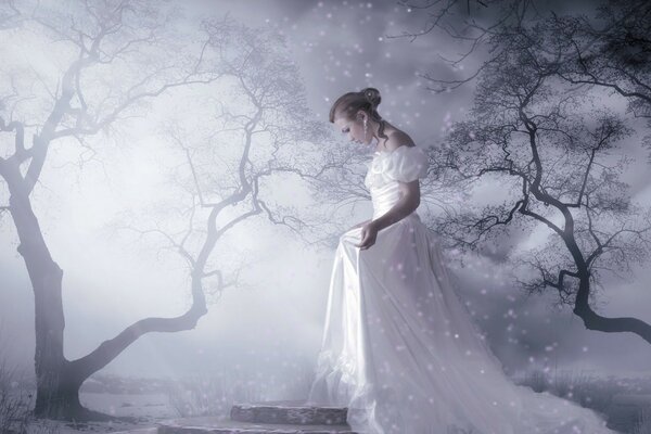 A girl in a white dress in the fog