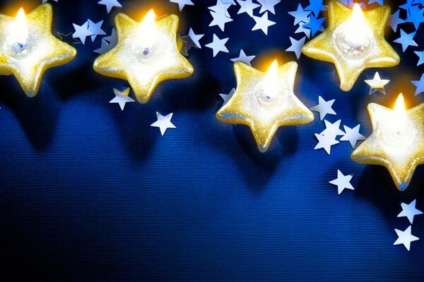 Golden candles stars on a blue background