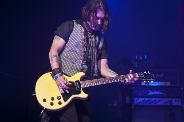 Portrait of a musician with a guitar at a concert