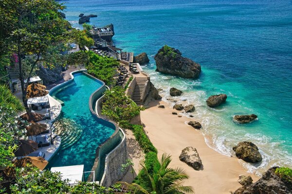 Swimming pool on the shore of the Azure sea