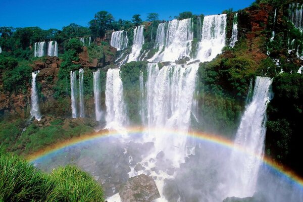 Big waterfalls and a rainbow under them