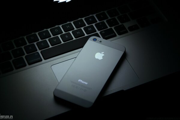 Black Apple Phone on Laptop