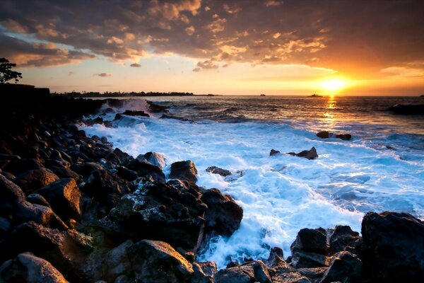White foam of water at sunset