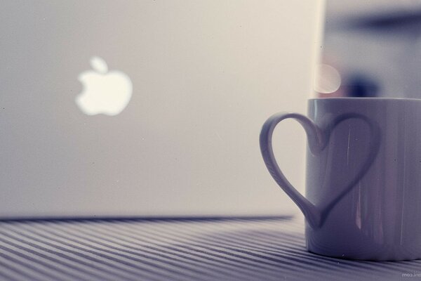 The mug next to the MacBook