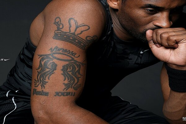 A dark-skinned athlete in tattoos. Nike